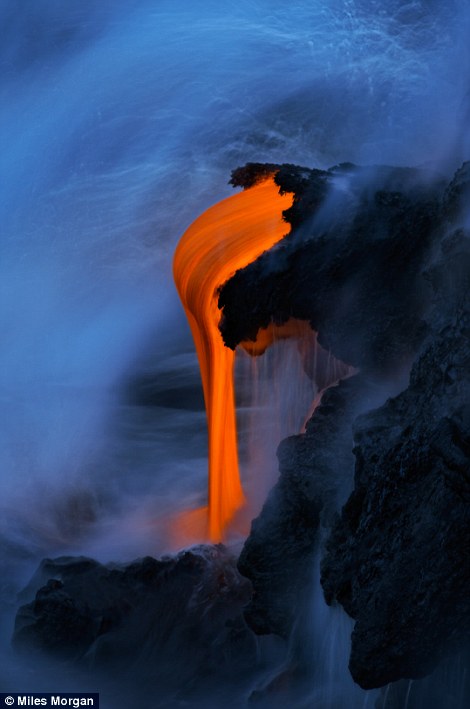 Lava from the Kilauea Volcano drips into the ocean during the ?blue hour? before dawn