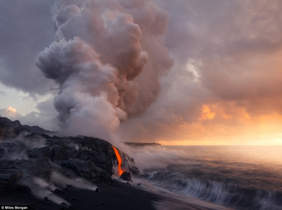 Overwhelming beauty: An angry plume of toxic steam and acid rain rolls up from an ocean entry of the Kilauea Volcano in stark contrast with soft sunrise light