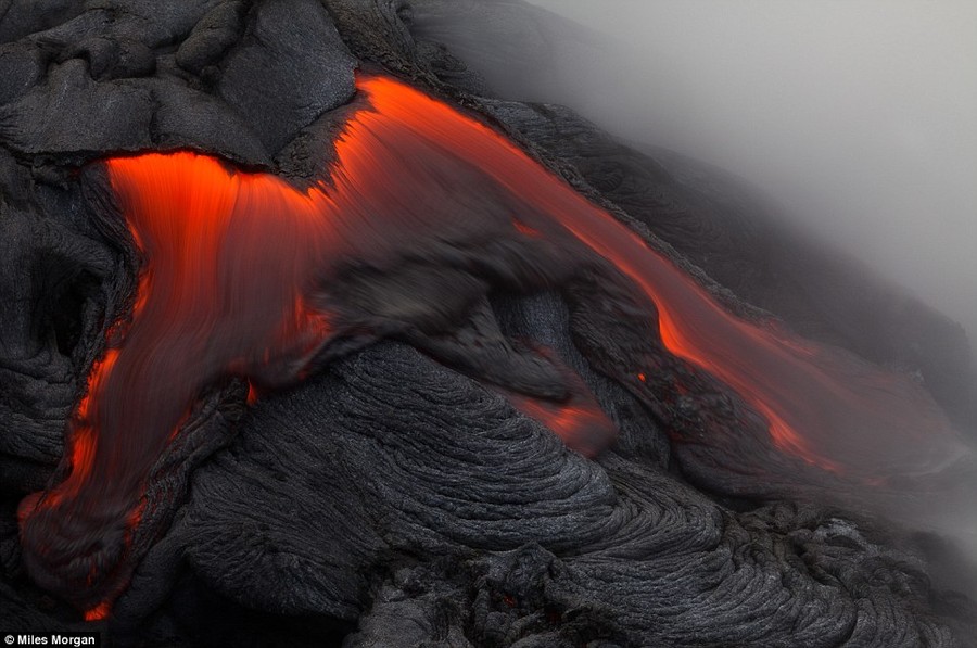 Bubbling cauldron: A surface breakout from the Kilauea Volcano approaches the water near Kalapana, Hawaii during the last ocean entry of 2011