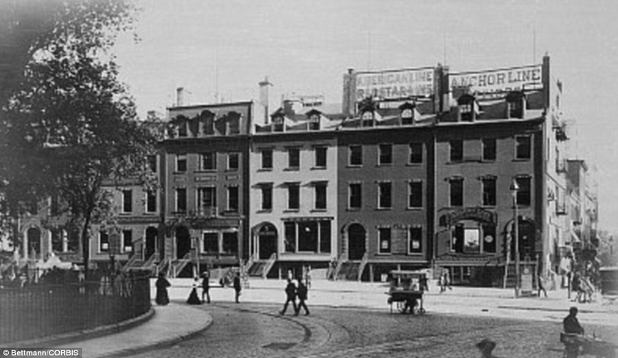 At the southern tip of Manhattan, Bowling Green with an old row of houses and Steamship Line offices