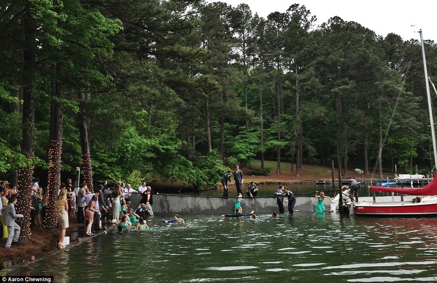 After: An image taken moments after the dock collapsed shows bridesmaids paddling for their lives