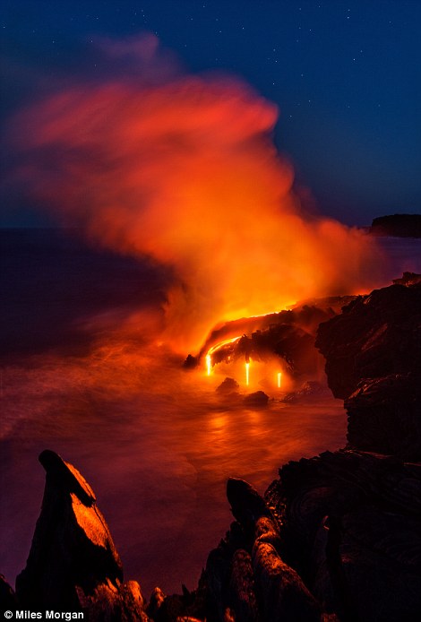 The last light of twilight over a large ocean entry from the Kilauea Volcano