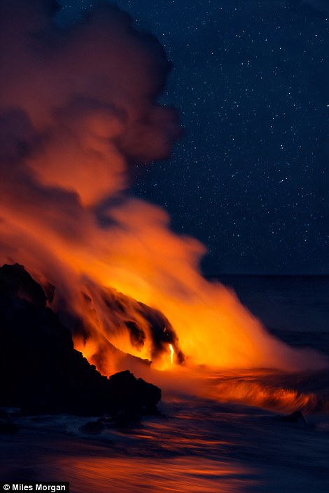 Lava pours into the ocean under the stars from the Kilauea Volcano long after sunset 