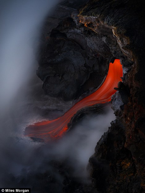 slide of molten hot lava from the Kilauea Volcano sizzles the ocean water