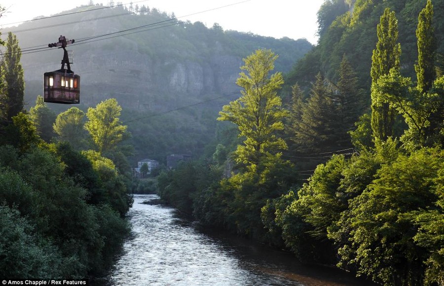 Crossing: A cable car dangles over a river at the bottom of the valley in Chiatura, Georgia