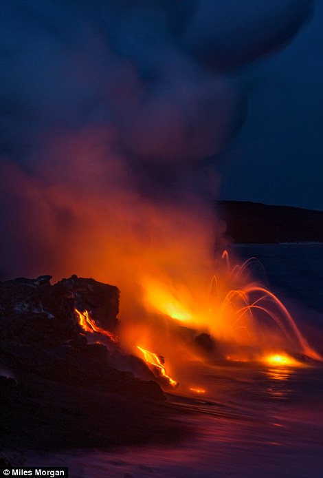 A huge ocean entry from the Kilauea Volcano sends lava exploding into the ocean just after sunset 